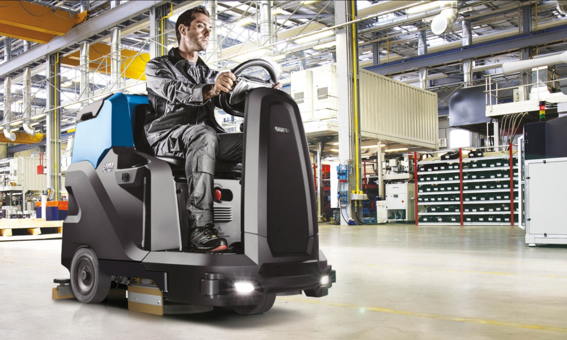 man using mmg plus floor cleaning machine to clean the warehouse floor