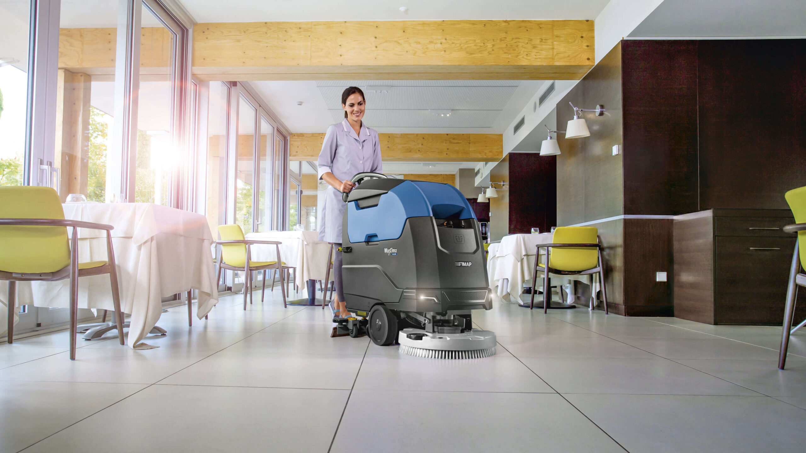 Woman Using Maxima 50 Floor Cleaning Machine In Restaurant